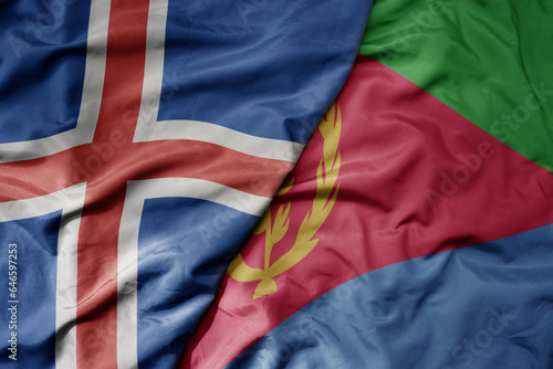 big waving national colorful flag of icelandic and national flag of eritrea .