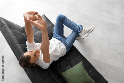 Young man resting on black ...
