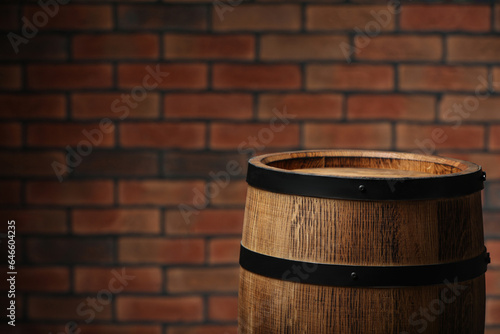 Wooden barrel near brick wall. Space for text