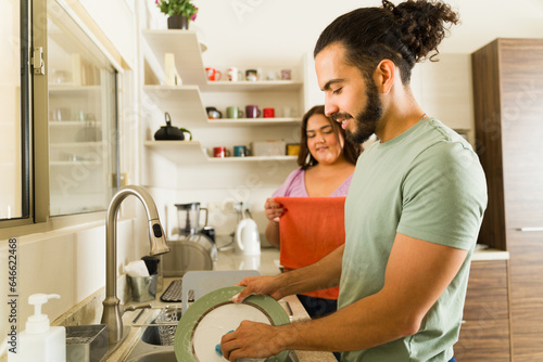 Konstfotografi Boyfriend and girlfriend washing the dishes doing house chores together