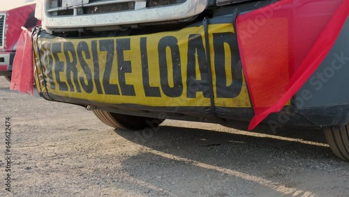 Oversize load banner and red flag on truck trailer. Close up shot