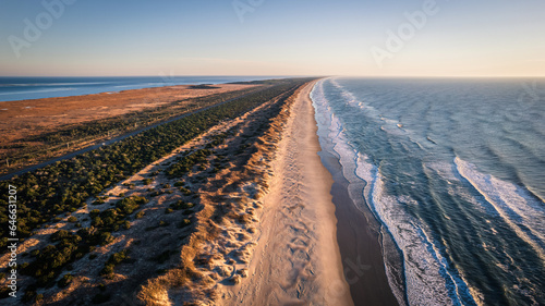 Aerial view of coastline and sand dunes of Ocracoke Island at sunrise, North Carolina, USA.