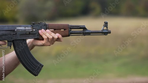 A man holding an AK 47 Machine Gun