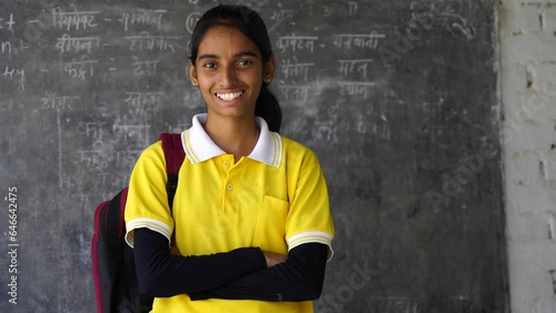 Happy Rural Indian student schoolgirls wearing school uniform holding books and bag standing together, Studio shot, Education concept.