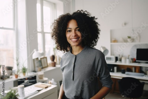 Smiling portrait of a happy young african american interior designer in a modern and contemporary apartment