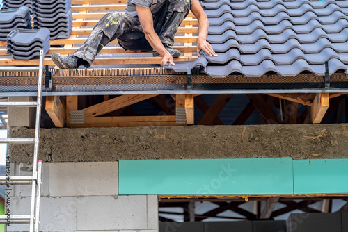 manual installation of roof covering made of ceramic tiles