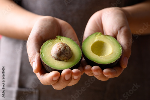 Ripe hass avocado fruit in hand, Healthy fruit