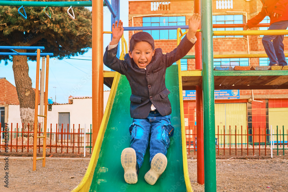 Φωτογραφία latino boy playing on a slide at an outdoor park in la paz, bolivia
