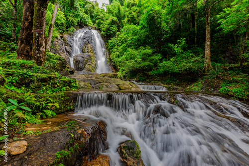 Background of a natural waterfall with cool water flowing from high mountains  Punyaban Waterfall Lamnam Kraburi National Park in Ranong Province  Thailand