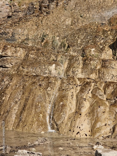 Concrete Covered Cliff with Rough Textured Surface photo