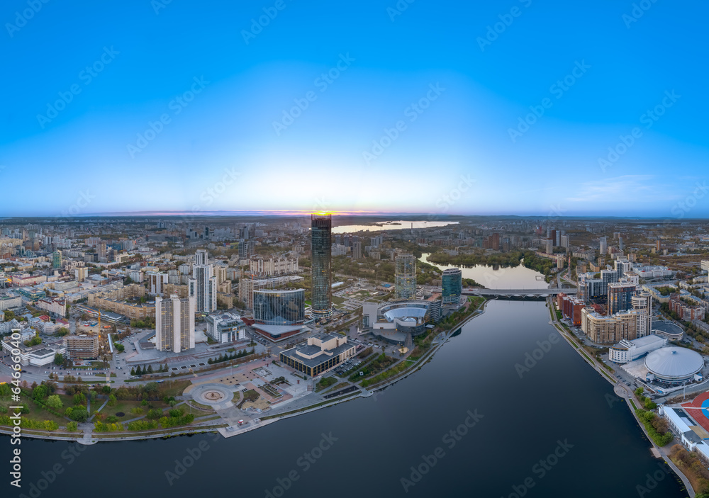 Yekaterinburg city and pond aerial panoramic view at summer or early autumn sunset. Night city in the early autumn or summer.