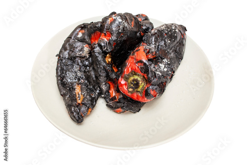 Roasted red kapia peppers on a gray ceramic plate isolated on white photo