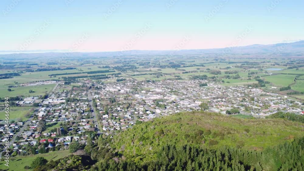 Flying parallel to a small town with fields and mountains in the background. Featherston, Wairarapa, New Zealand. Flying parallel to a small town with fields and mountains in the background. Featherston, Wairarapa, New Zealand.