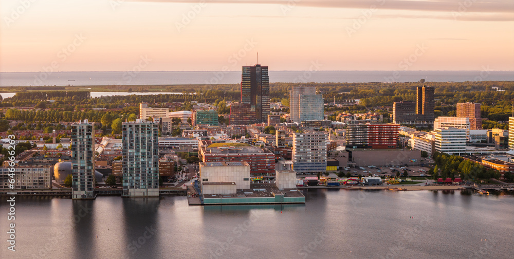 Almere city center, modern suburban town near Amsterdam, province Flevoland in The Netherlands. Aerial view at sunset.