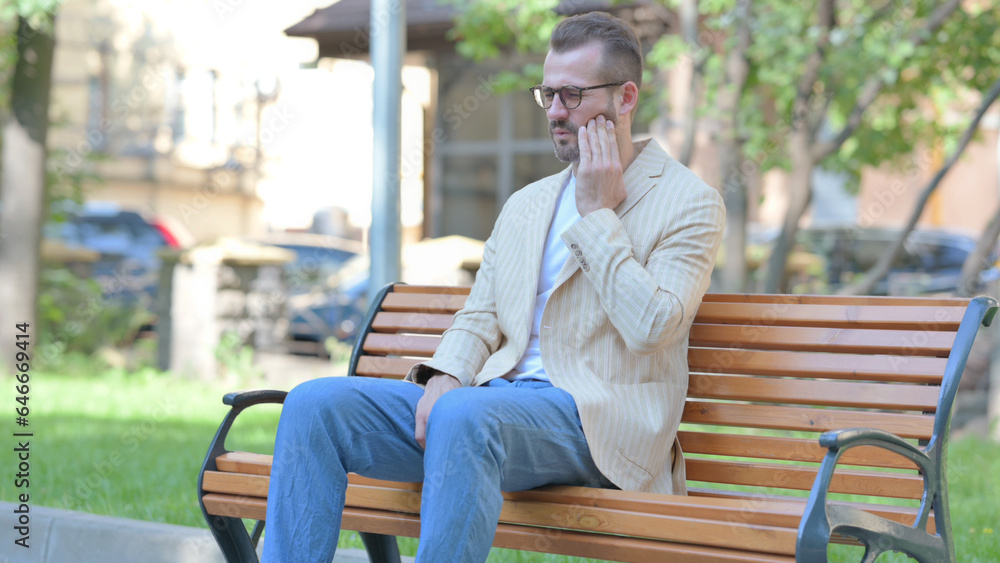 Fototapeta premium Middle Aged Man with Toothache Sitting Outdoor