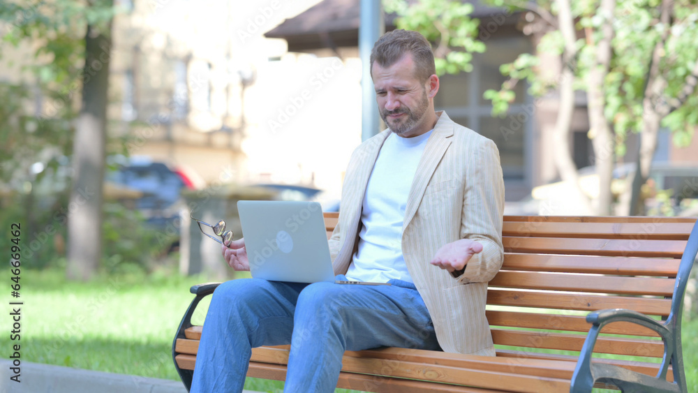 Fototapeta premium Middle Aged Man Shocked by Loss on Laptop Outdoor