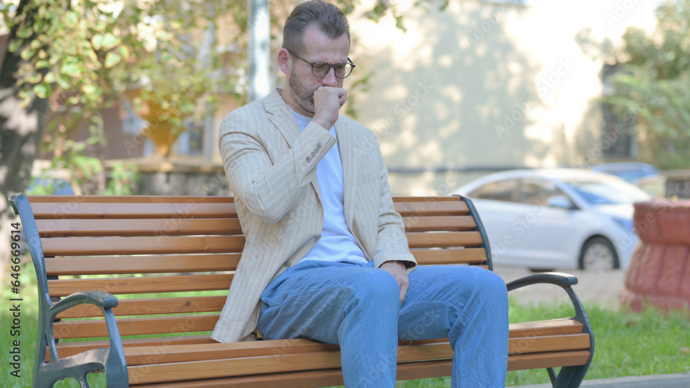 Fototapeta premium Coughing Modern Casual Man Sitting Outdoor