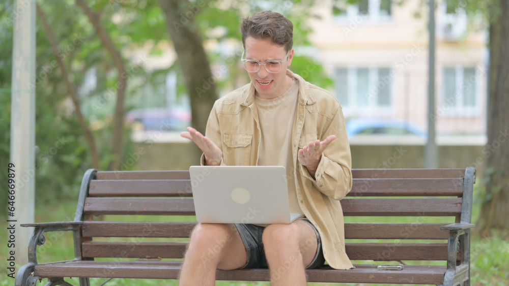 Casual Young Man Shocked by Loss on Laptop Outdoor Casual Young Man Shocked by Loss on Laptop Outdoor