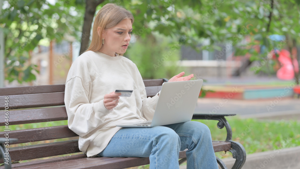 Young Woman Upset by Online Payment Failure on Laptop Outdoor