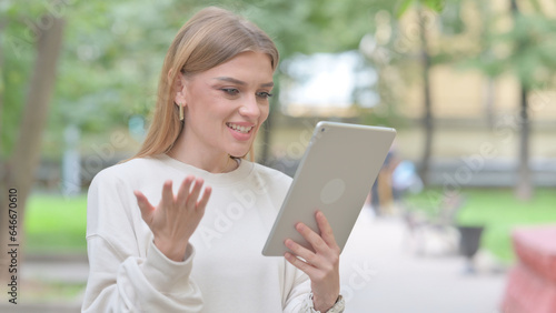 Woman Doing Video Chat on Tablet Outdoor
