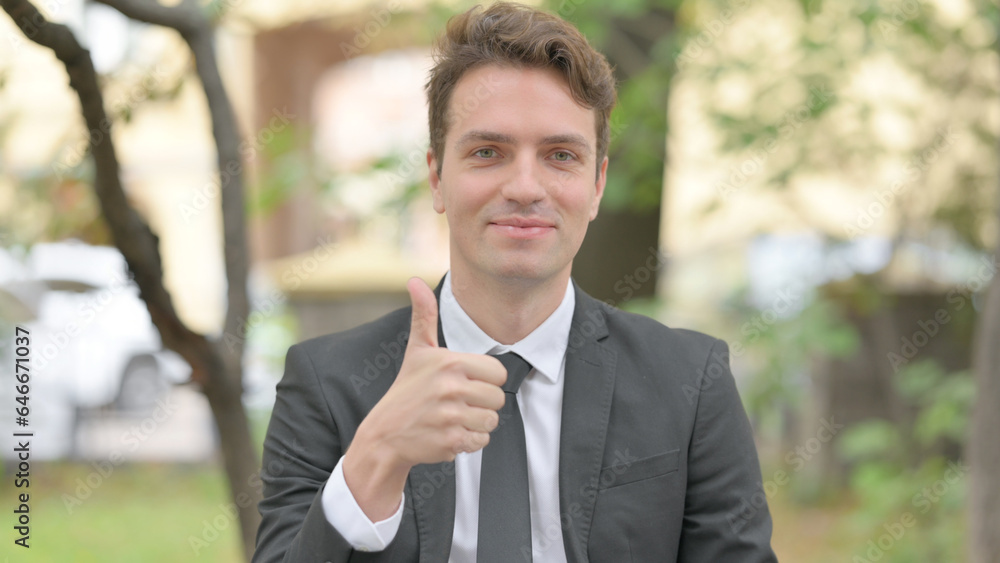 Outdoor Portrait of Businessman with Thumbs Up