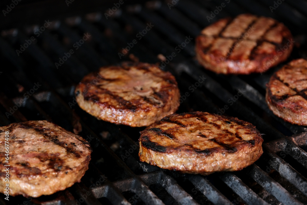 Barbecuing plant based Impossible Burger patties on electric grill semi close up shot panning over spatula flipped and grilled brown seasoned burger patties in Cinema. 4k Barbecuing plant based Impossible Burger patties on electric grill semi close up shot panning over spatula flipped and grilled brown seasoned burger patties in Cinema. 4k