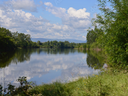 Beautiful summer landscape with river and blue sky with clouds reflected in water. Russia. Nature of Eastern Siberia.
