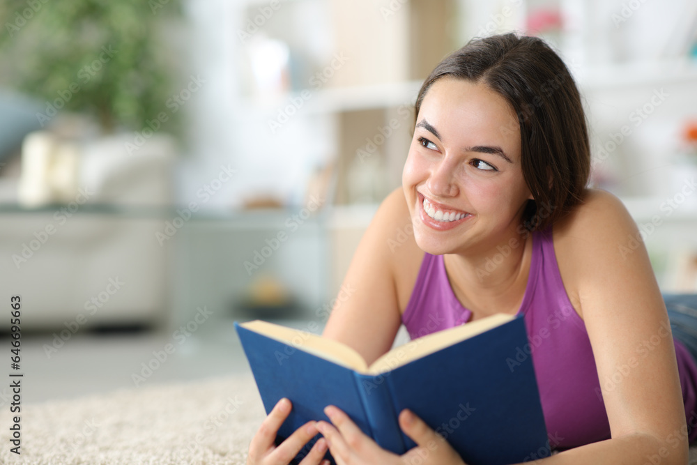 Happy paper book reader thinking looking at side