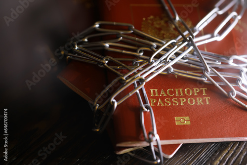 Russia Sanctions and banned russian people, Russian Federation passports with padlock and chain. Text translation Russian Federation