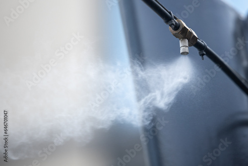 Fotografie Sprinkler head from a high pressure outdoor cooling system for cafe, close-up, copy space