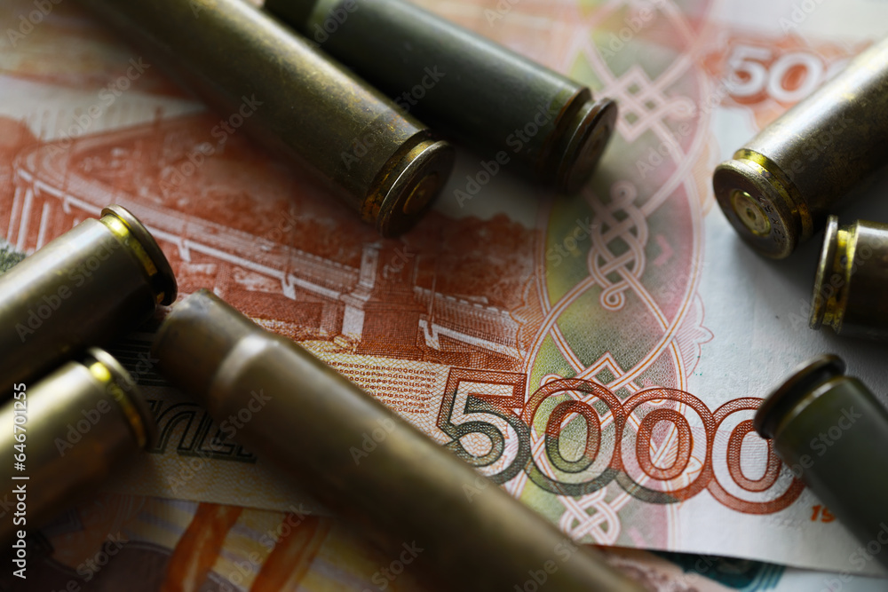 Bullets lie on the russians money money with inscription five thousands rubles top view