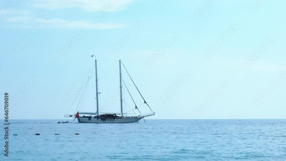 Leisure vacation on alone motor yacht. A view of summer leisure with sailing yacht against clear sky under sun rays. Leisure vacation on alone motor yacht. A view of summer leisure with sailing yacht against clear sky under sun rays.
