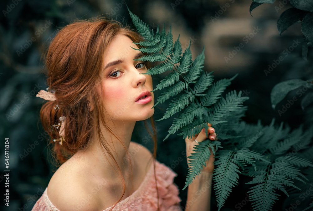 Portrait of a beautiful red hair girl in a pink vintage dress standing near colorful flowers. Art work of romantic woman .Pretty tenderness model . Portrait of a beautiful red hair girl in a pink vintage dress standing near colorful flowers. Art work of romantic woman .Pretty tenderness model .
