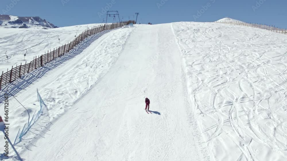 Aerial shot overhead a single skier down a ski slope in the Farellones, Chile Aerial shot overhead a single skier down a ski slope in the Farellones, Chile