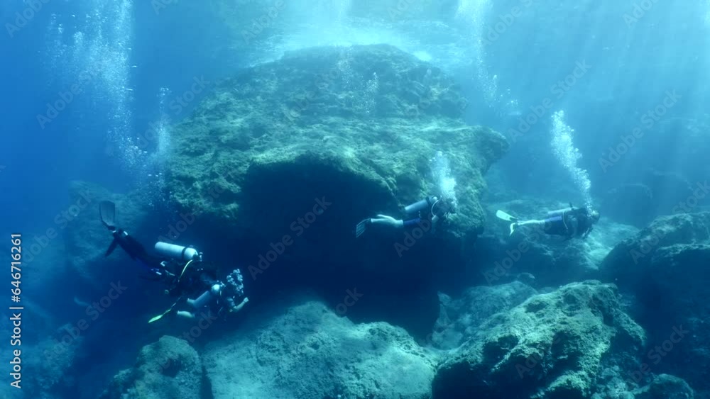 scuba divers exploring underwater topography big rocks scuba divers exploring underwater topography big rocks