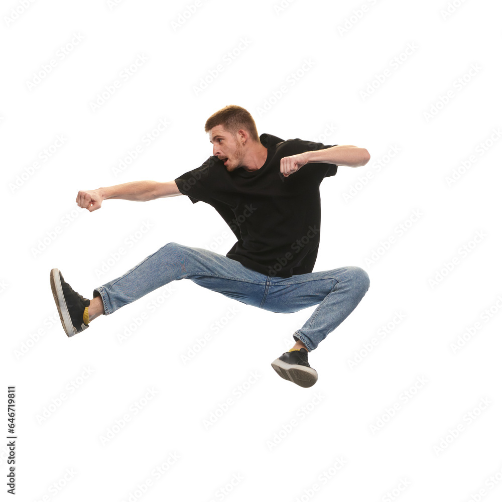 Overcoming difficulties. Young man jumping in fighting pose isolated on white background. Concept of youth, active lifestyle, motivation, emotions and facial expression. Ad Overcoming difficulties. Young man jumping in fighting pose isolated on white background. Concept of youth, active lifestyle, motivation, emotions and facial expression. Ad