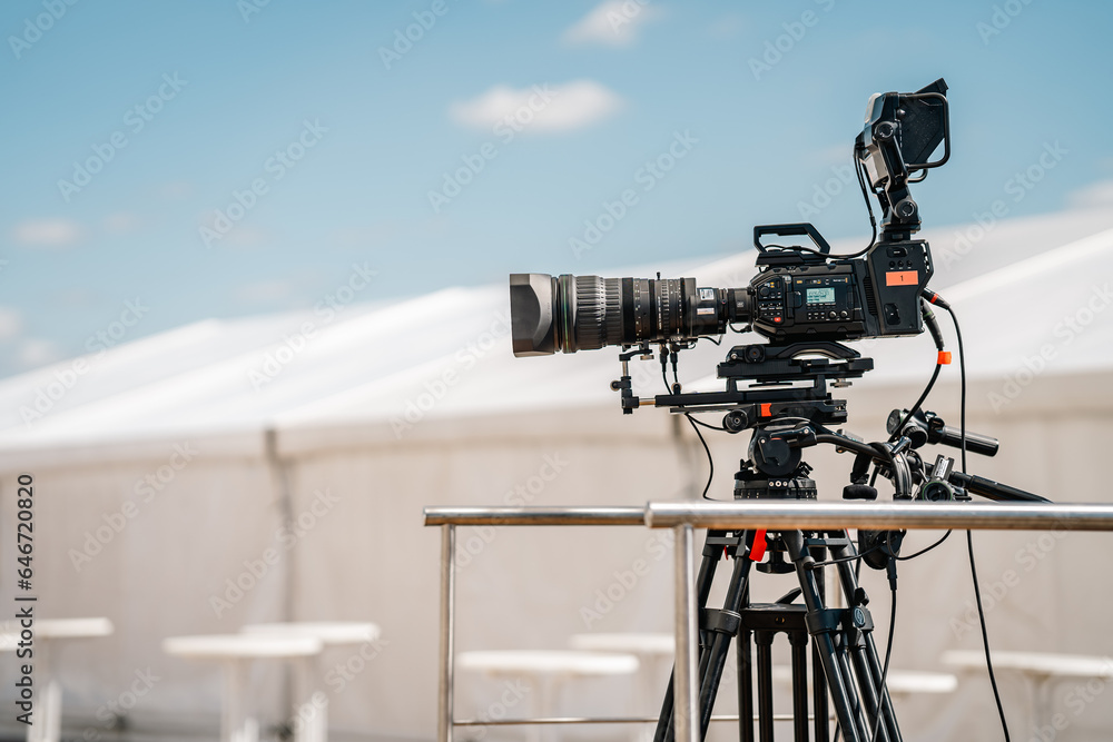 Professional Live TV Video Camera Setup on a Tripod , Outdoors on a Sunny Day, Professional Equipment Professional Live TV Video Camera Setup on a Tripod , Outdoors on a Sunny Day, Professional Equipment