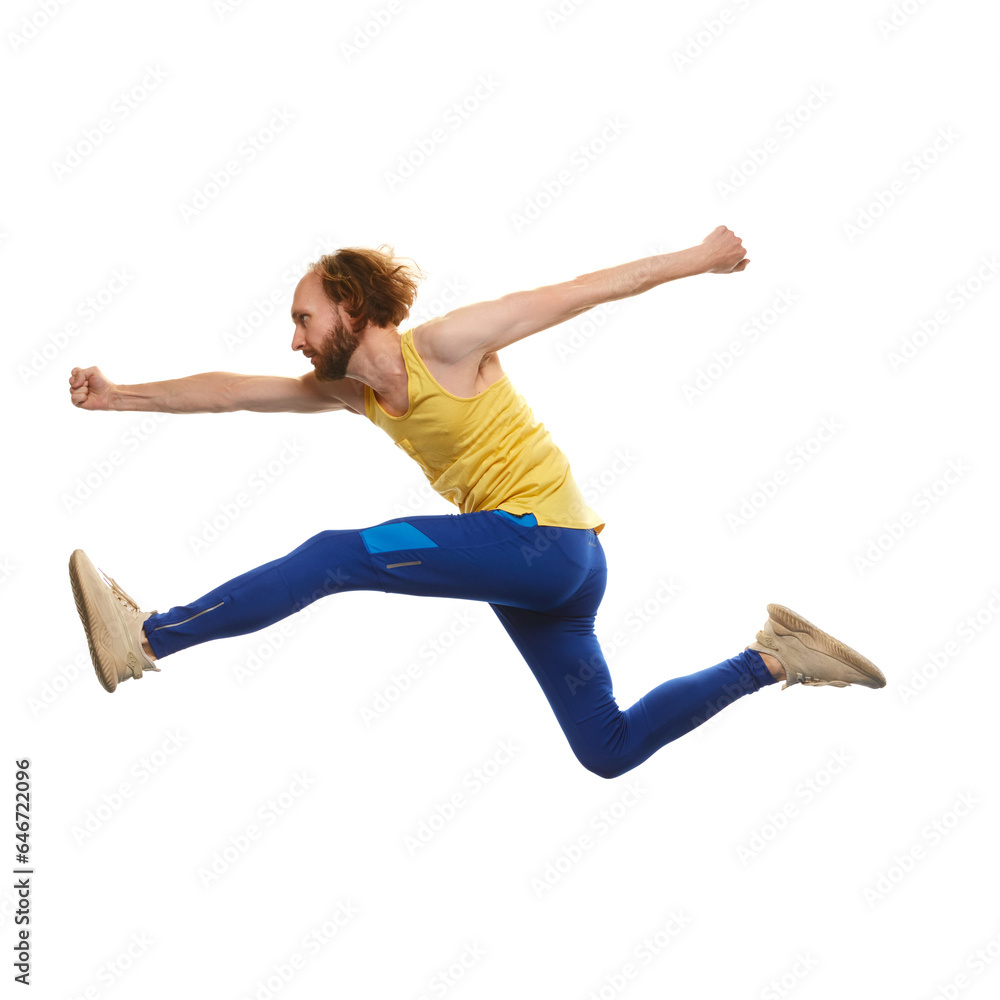 Young man in sportswear running in a jump isolated on white background. Overcoming difficulties. Motivation. Concept of youth, active lifestyle, motivation, emotions and facial expression. Ad