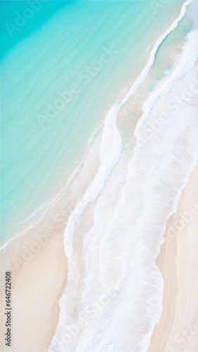 A majestic aerial view  of a sandy beach with crystal blue water washing up on shore.