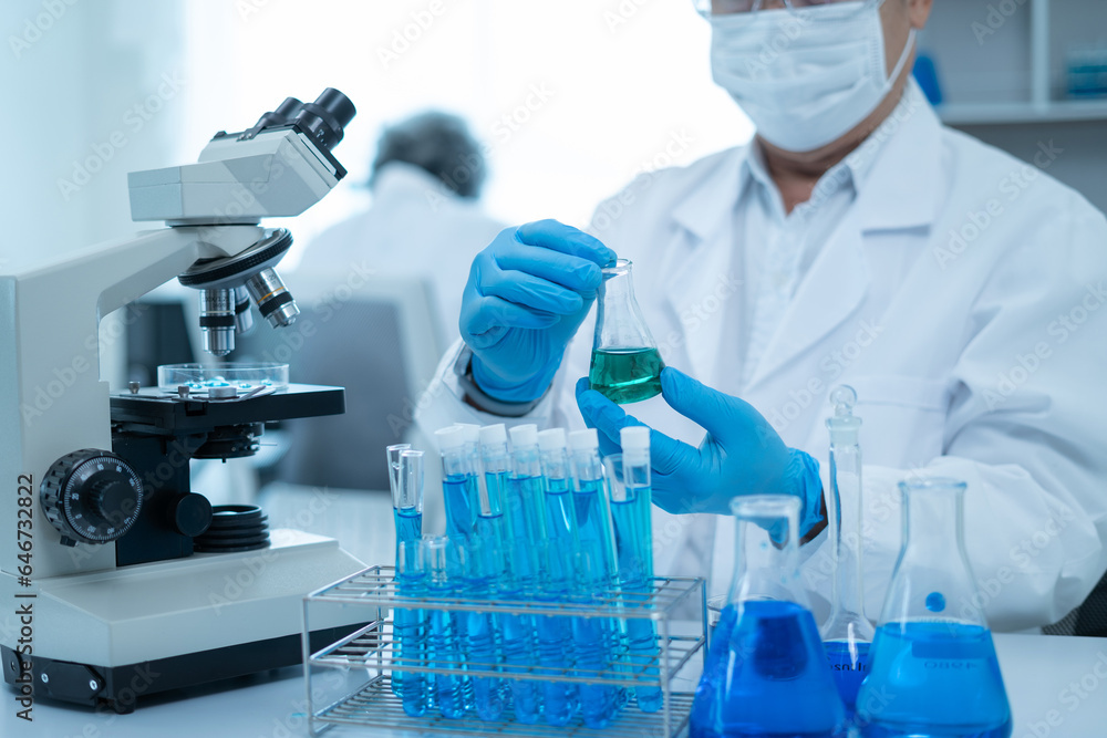 Scientist works with a pipette and a test tube. Scientific laboratory of biotechnology, development of medicine and research in chemistry, biochemistry and experiments. Scientist works with a pipette and a test tube. Scientific laboratory of biotechnology, development of medicine and research in chemistry, biochemistry and experiments.