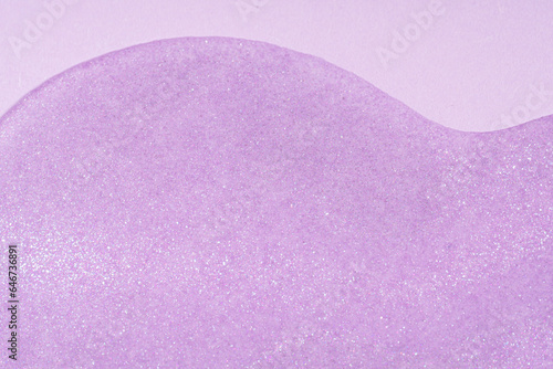 Light purple glitter sparkle confetti background liquid drops of paint color flow down on purple background. Lavender glitter paint dripping on the wall.