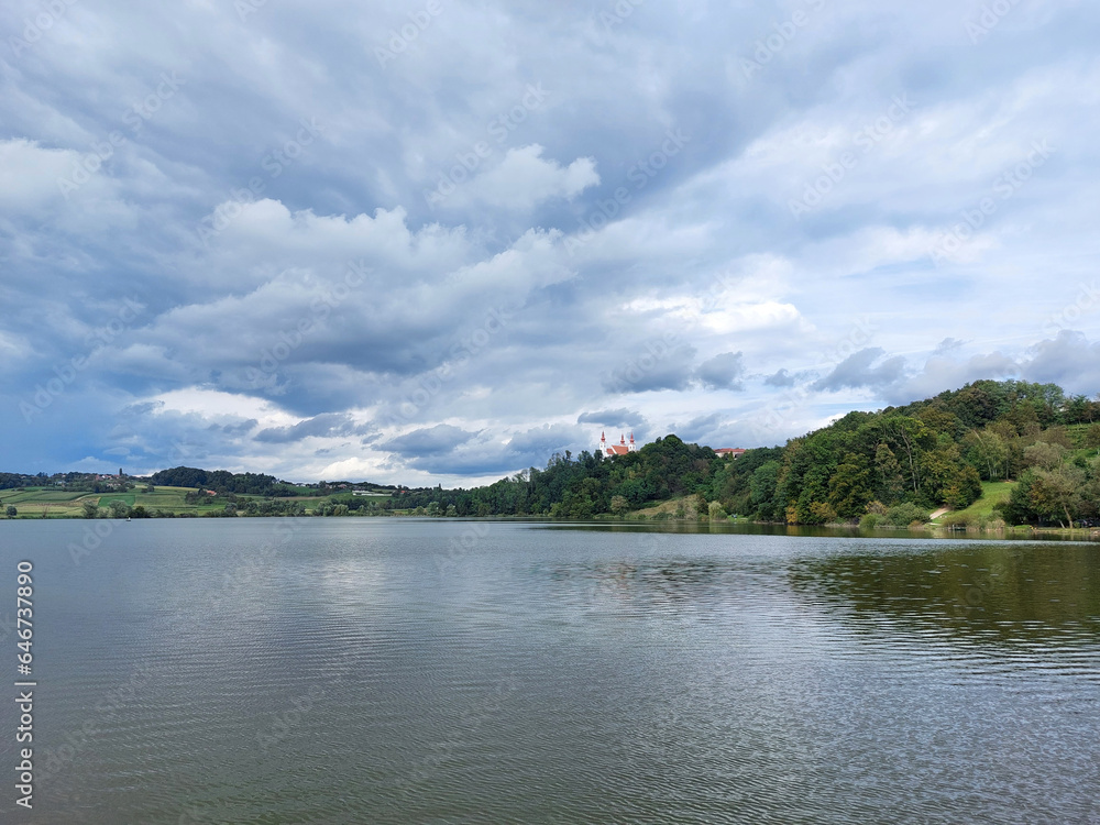 lake near Church of the Holy Trinity in Slovenske Gorice under cloudy sky. Slovenia
