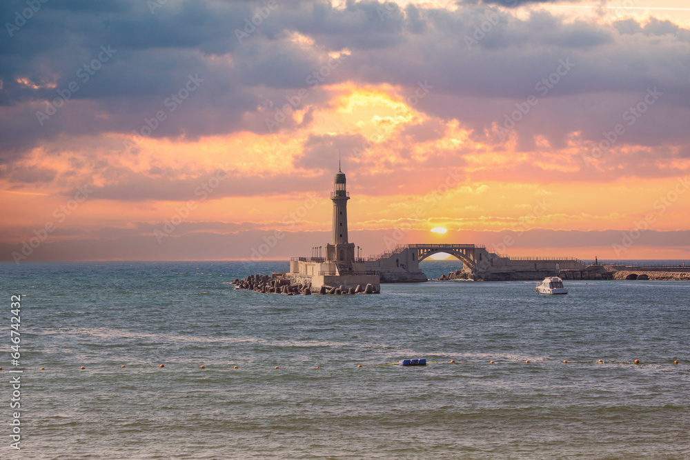 Fototapeta premium Magical Sunset Over Montaza Palace Lighthouse, Mediterranean Sea, Alexandria, Egypt