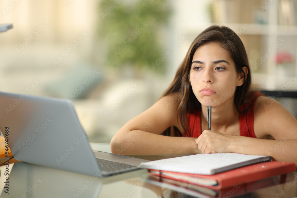 Bored student wasting time at home Bored student wasting time at home