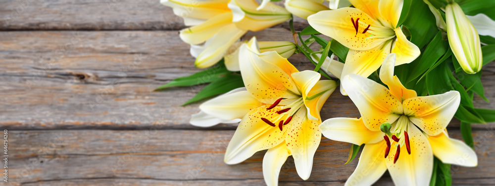 Obraz premium Lily flowers on a wooden background bright color background