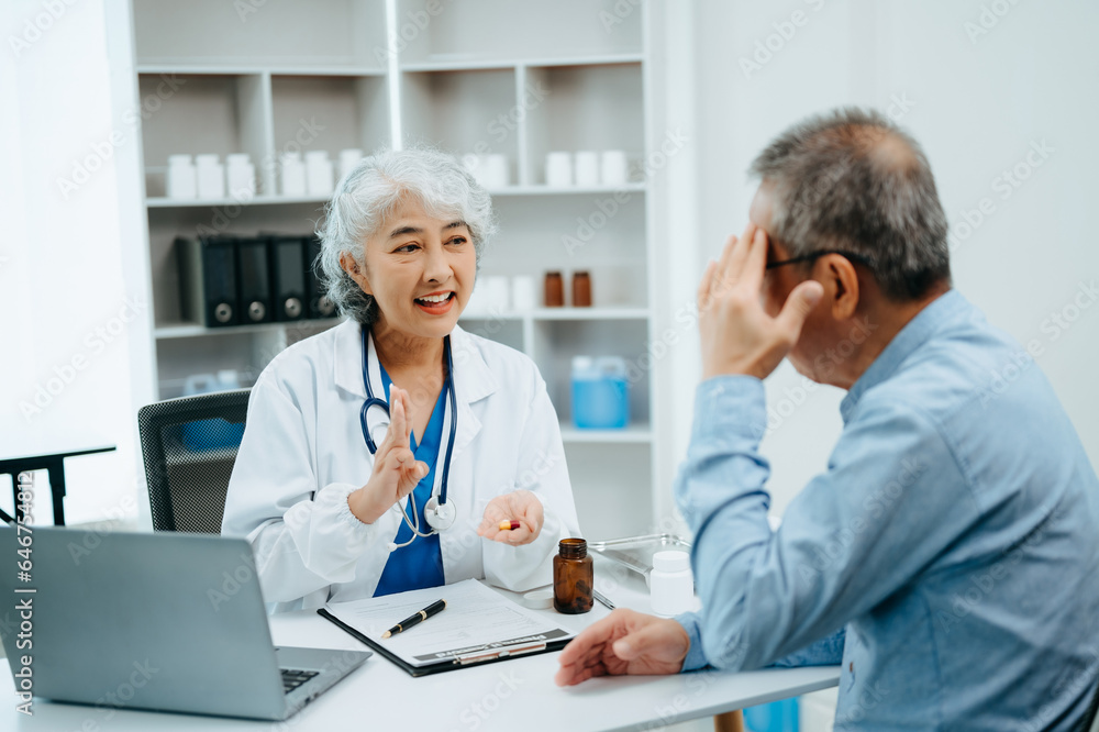 Asian Senior Doctor and patient discussing something while sitting at the table . Medicine and health care concept. Asian Senior Doctor and patient discussing something while sitting at the table . Medicine and health care concept.