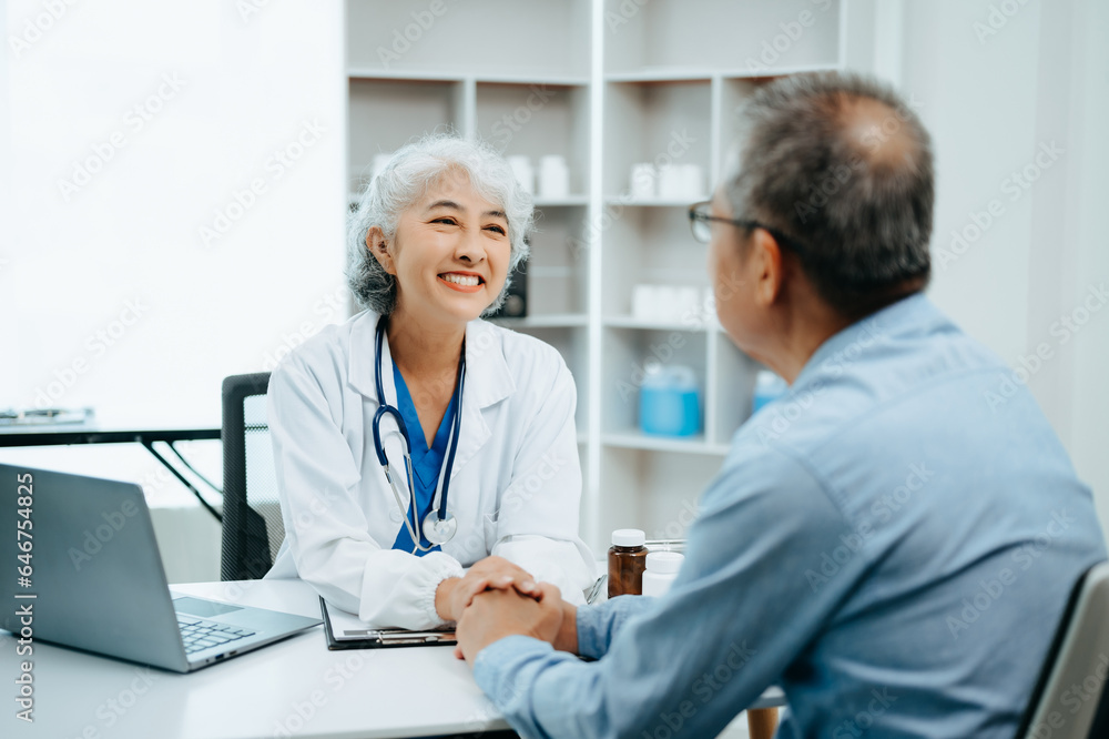 Asian Senior Doctor and patient discussing something while sitting at the table . Medicine and health care concept. Asian Senior Doctor and patient discussing something while sitting at the table . Medicine and health care concept.