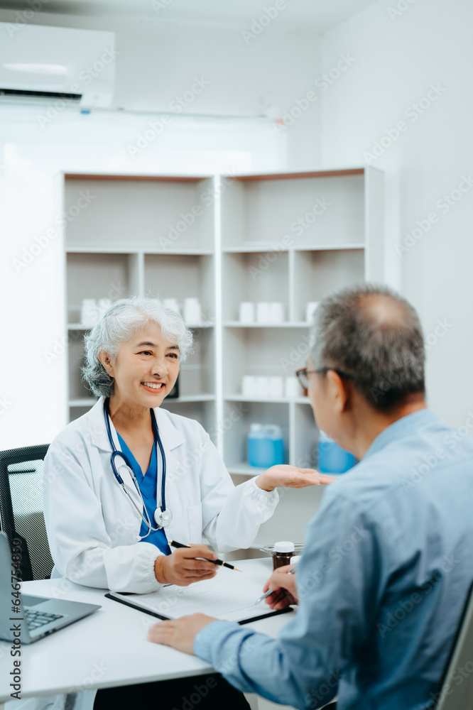 Asian Senior Doctor and patient discussing something while sitting at the table . Medicine and health care concept. Asian Senior Doctor and patient discussing something while sitting at the table . Medicine and health care concept.