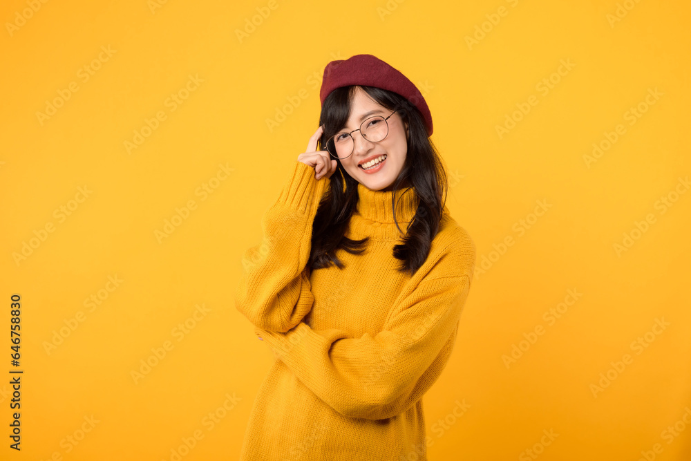Portrait beautiful young asian woman 30s enterpriser happy smile dressed in yellow sweater and red hat showing thinking gesture isolated on yellow studio background Portrait beautiful young asian woman 30s enterpriser happy smile dressed in yellow sweater and red hat showing thinking gesture isolated on yellow studio background