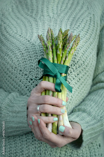 Bundle of Fresh Green Asparagus Held by a Woman s Hands